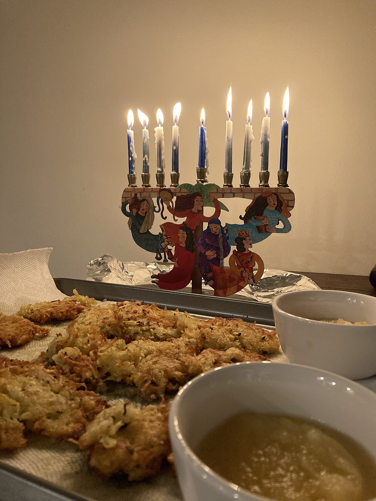 Kosher foods for Hanukkah: latkes beside a lit menorah